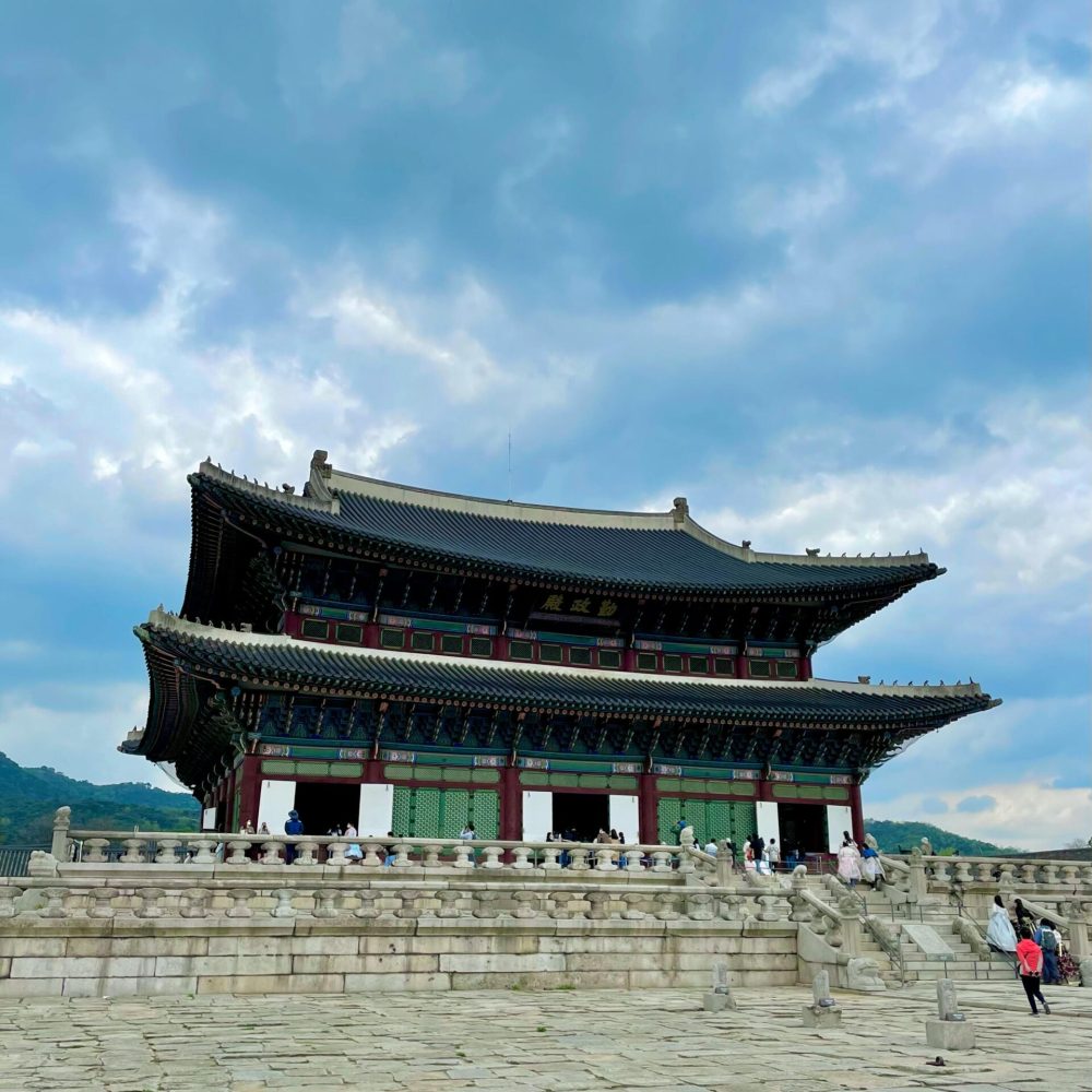 Geunjeongjeon Hall of Gyeongbokgung Palace in Seoul, showcasing traditional Korean architecture against a blue sky.